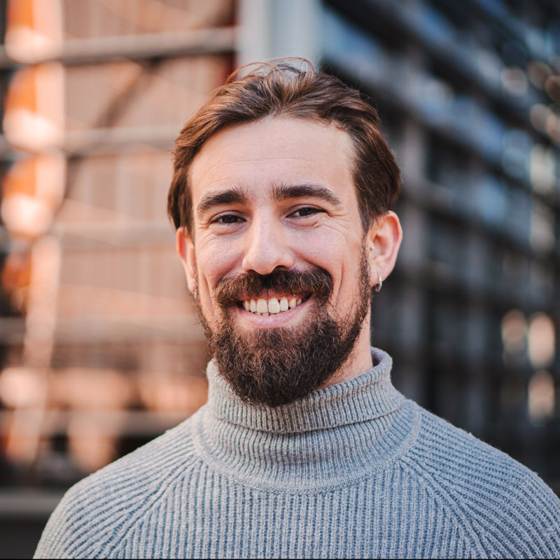 man in turtle neck smiling